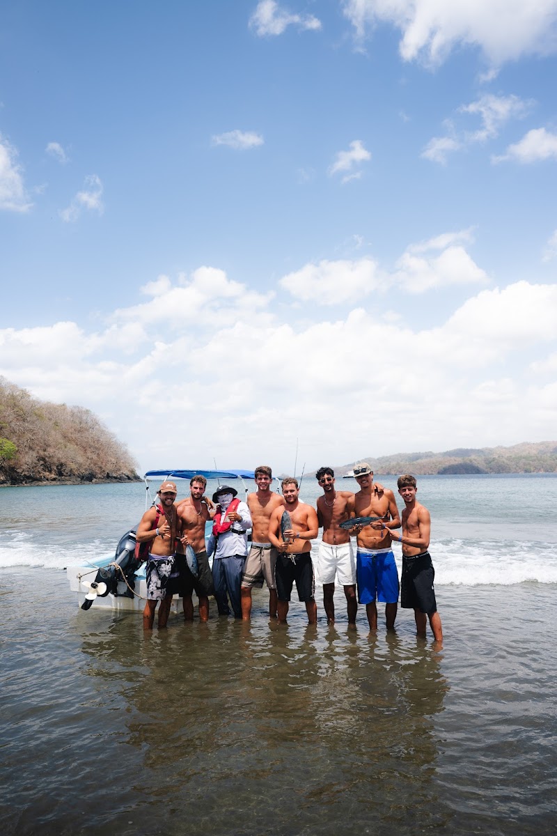 The Playa Venao Adventures crew standing on the beach with the day's tuna catch
