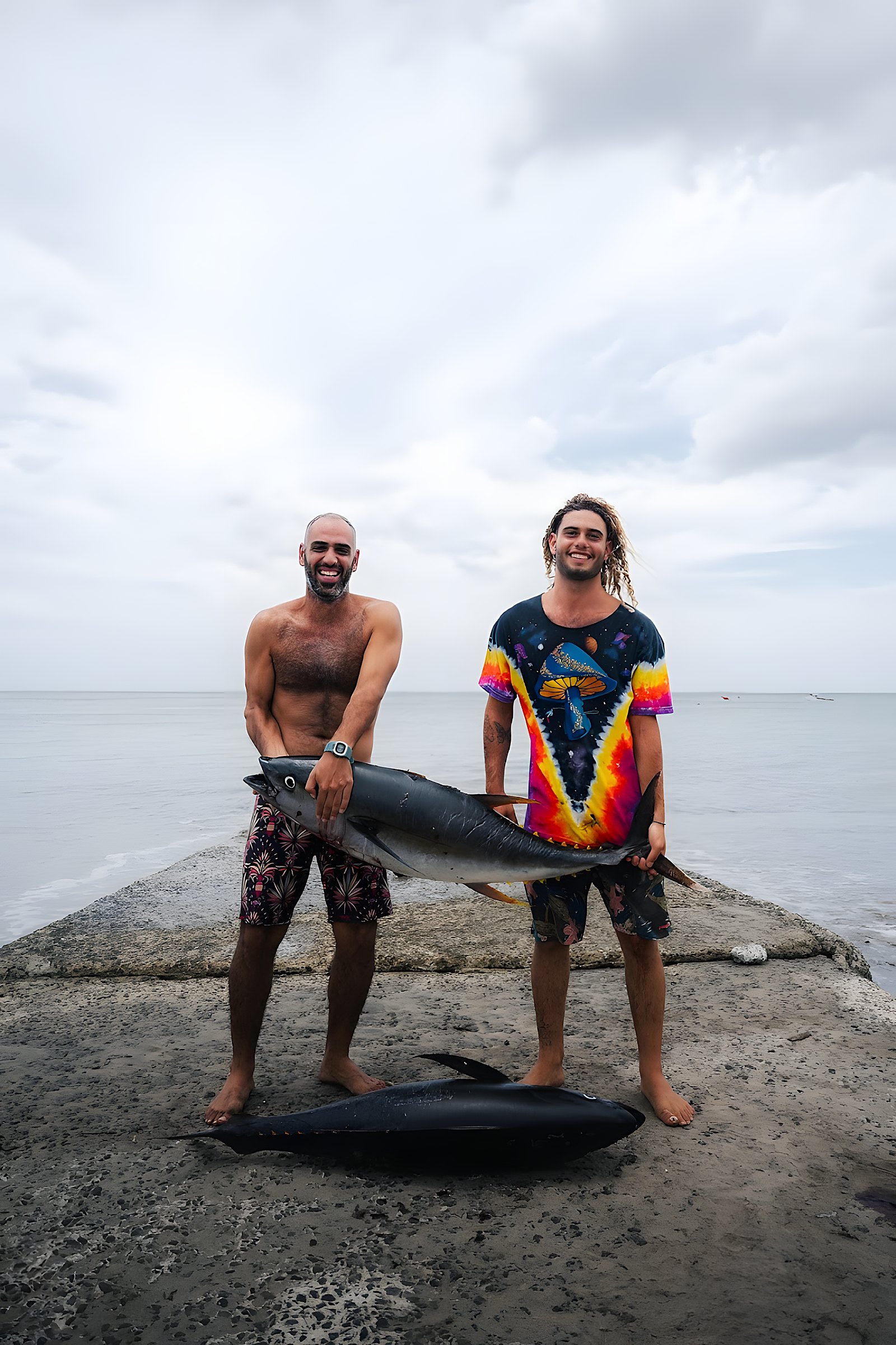 Two anglers on the jetty holding the day's tuna catch, Playa Venao, Panama