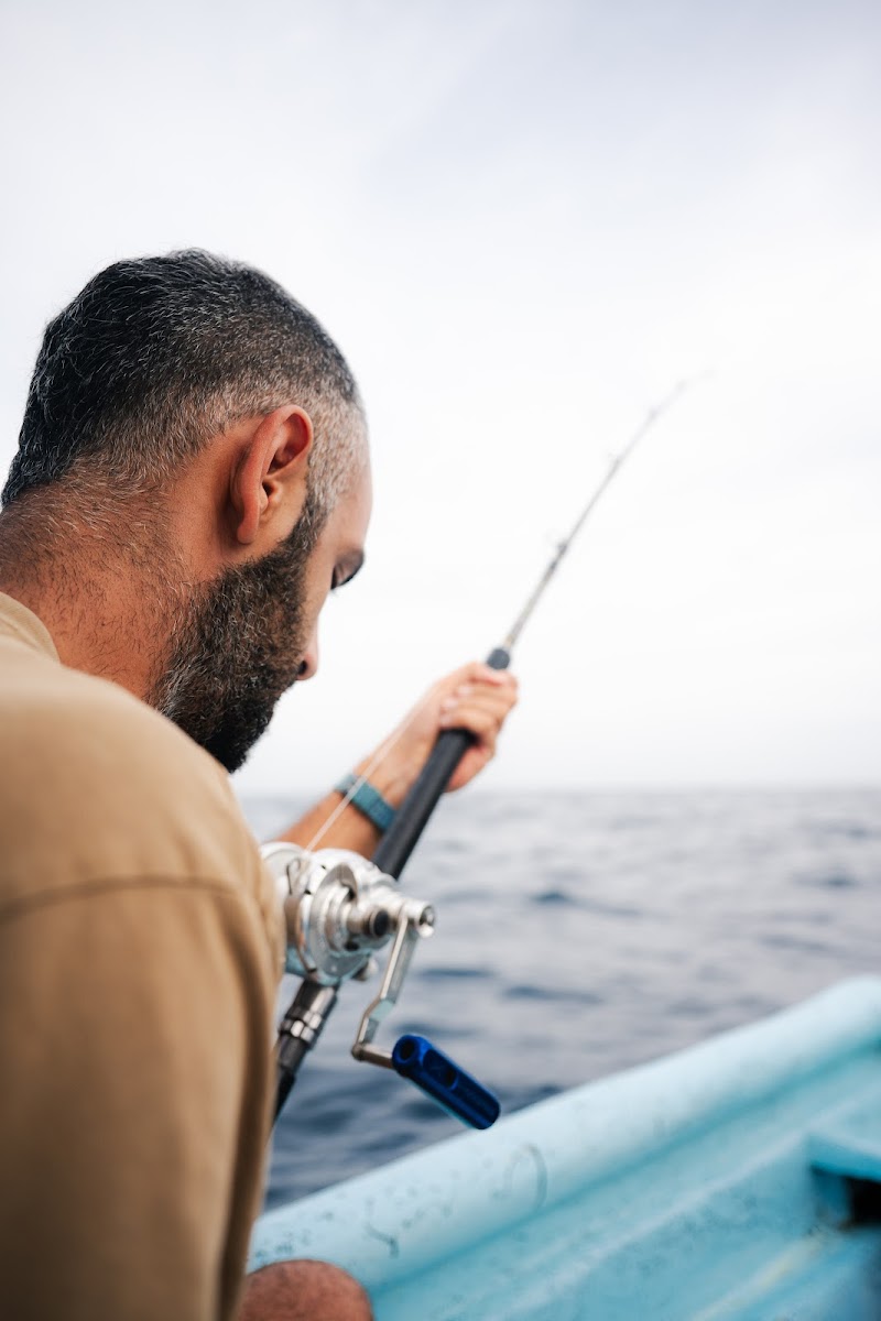 Angler fighting a fish offshore on a deep-sea charter